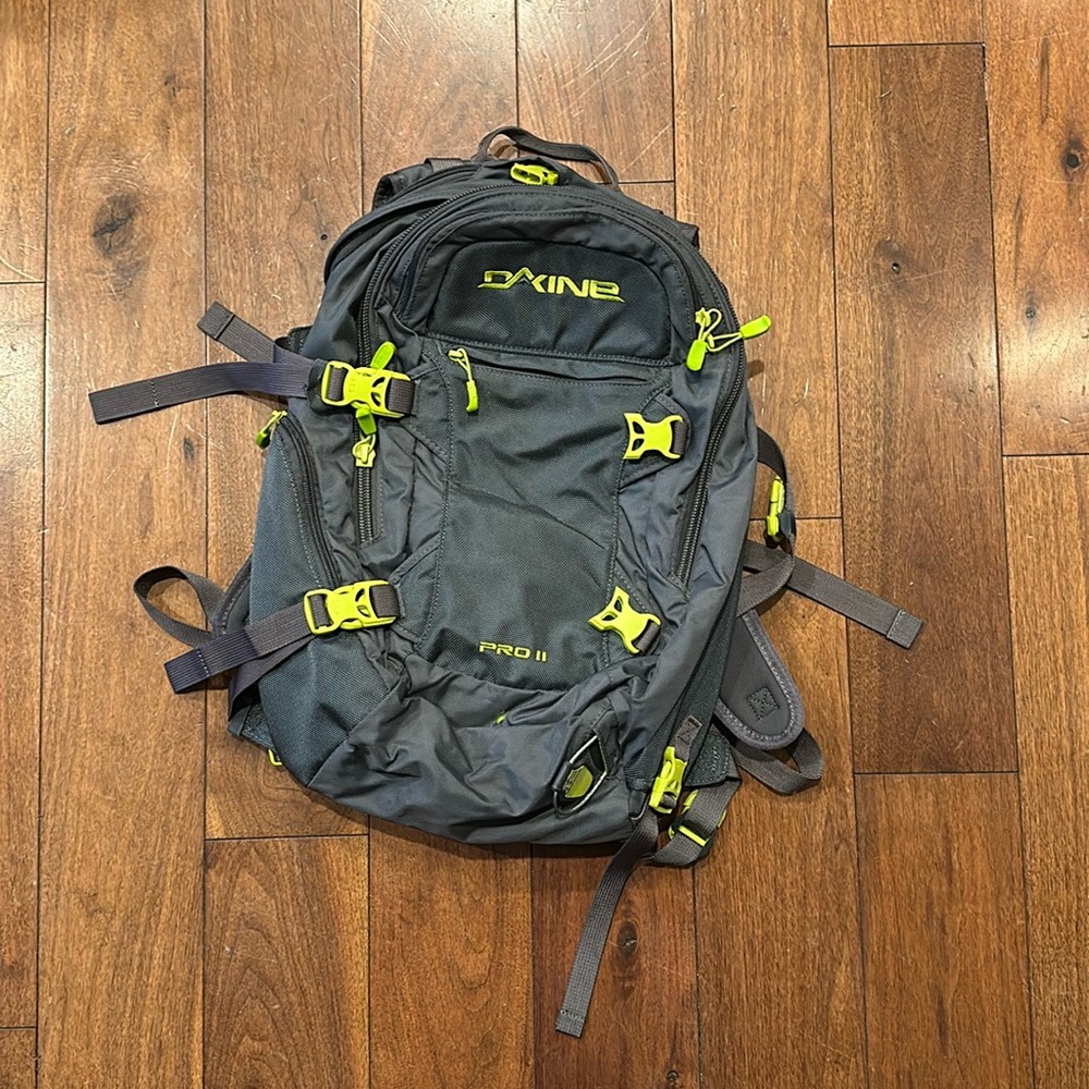 Grey and green Dakine Pro II snowboarding backpack